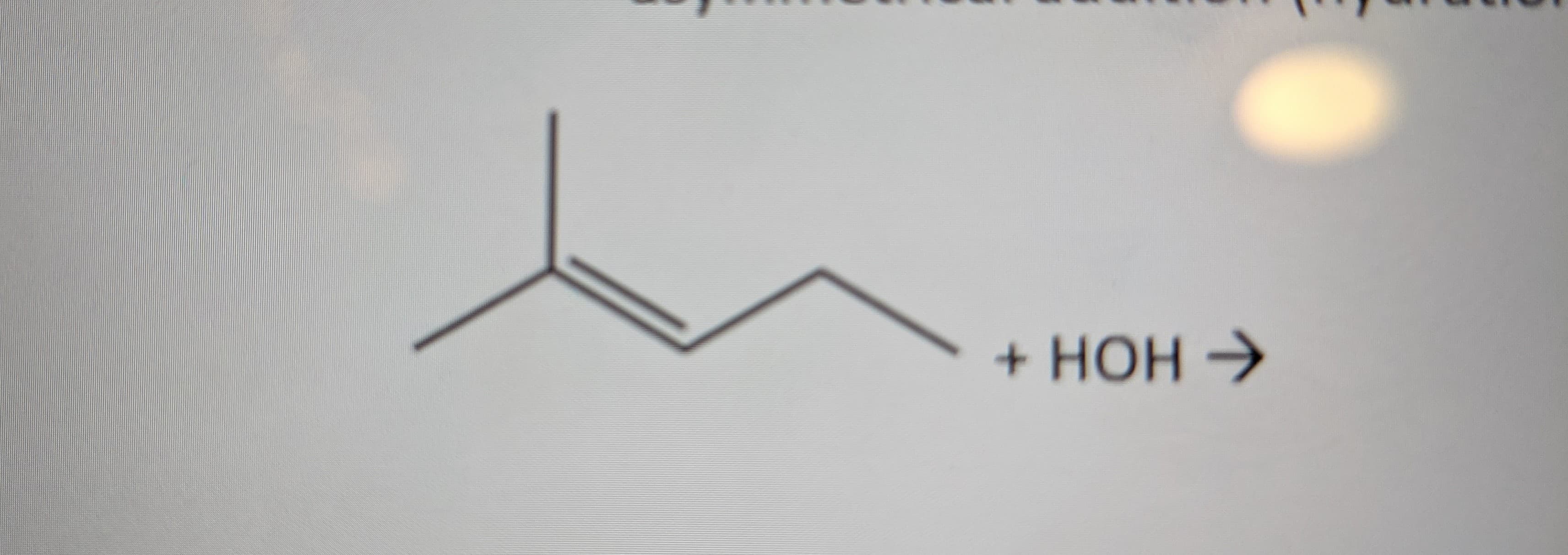 The image depicts a chemical reaction formula. This formula shows the interaction between an organic compound and water.

**Chemical Reaction:**

\[ \text{Alkene} + \text{H}_2\text{O} \rightarrow \text{Product} \]

In detailed structural terms:

- The reactant is an alkene, specifically 2-methyl-2-butene, which has a double bond between two carbon atoms.
- Water (\(\text{H}_2\text{O}\)) is the reactant added to the alkene.

**Explanation of the Reaction:**
This reaction is an example of a hydration reaction, which is a symmetrical chemical addition. In a hydration reaction, water adds across the double bond of an alkene, typically forming an alcohol.

**Key Points:**
- **Alkene:** 2-methyl-2-butene is the starting compound, characterized by a double bond, and its structural formula is shown.
- **Water Addition:** Represented as \(\text{+ HOH}\), where water molecule will add across the double bond.
  
This type of reaction is fundamental in organic chemistry, especially important in the formation of alcohols from alkenes.