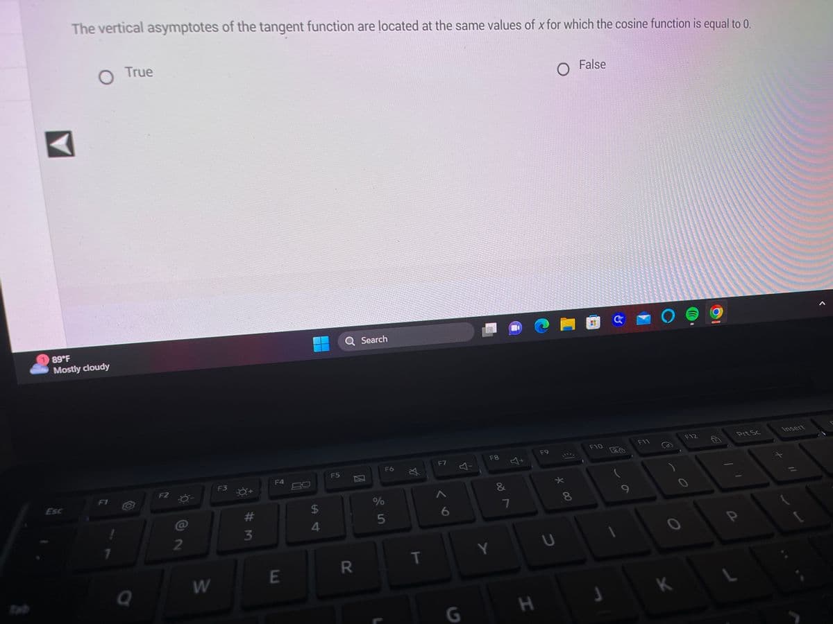 ---

**Question:**

The vertical asymptotes of the tangent function are located at the same values of \( x \) for which the cosine function is equal to 0.

- ○ True
- ○ False

---

**Explanation:**

This question is related to the properties of the trigonometric functions tangent and cosine. 

In trigonometry, the tangent function, \(tan(x)\), has vertical asymptotes where the cosine function, \(cos(x)\), has zeroes. The reason for this is that the tangent function is defined as the ratio of the sine function to the cosine function, \(tan(x) = \frac{sin(x)}{cos(x)}\). When \(cos(x) = 0\), the function becomes undefined because division by zero is undefined. Therefore, vertical asymptotes occur at these values.

### Graph/Diagram:

Although there is no graph in the provided image, let's conceptualize the relationship.

If we were to graph the cosine function, we would identify the points where \(cos(x) = 0\). These occur at: 
\[x = \frac{\pi}{2} + k\pi\]
where \(k\) is any integer.

In turn, on a graph of the tangent function, we would see vertical asymptotes at these same values of \(x\):
\[x = \frac{\pi}{2} + k\pi\]

Visually, a tangent graph repeats every \(\pi\) units and has vertical lines (asymptotes) where it shoots up to \(\infty\) and down to \(-\infty\) at these critical points.

By answering 'True' to this question, students affirm their understanding that the vertical asymptotes of the tangent function directly correspond to the zeros of the cosine function.

---