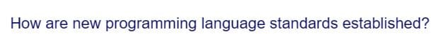 How are new programming language standards established?