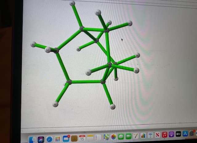 The image depicts a 3D molecular structure model shown on a computer screen. This digital model appears to be displayed using specialized chemistry or molecular visualization software. The software interface shows a molecule with a complex structure, rendered in green and gray sticks.

### Detailed Description of the Molecular Structure:

- **Primary Structure**: The molecule appears to have multiple interconnected rings and chains.
- **Atoms and Bonds**: 
  - The green sticks likely represent bonds between atoms or specific types of atoms (depending on the software and coloring conventions).
  - The gray spheres at the ends of the green sticks represent hydrogen atoms (H).
  - The gray sticks connecting the green sticks may represent other types of bonds, possibly involving carbon atoms, though exact elements and bonds are not specifically labeled.
  
### Software Interface:

- **Top Section**: The top section shows an empty space suggesting that it might be an area for rendering or additional information.
- **Bottom Section**: The bottom part of the image displays various icons and shortcuts characteristic of a typical macOS Dock. These icons include system applications such as Finder, system preferences, and several other application shortcuts for quick access.

### Educational Implications:

This 3D model can be used to illustrate:

- **Chemical Bonding**: Different types of bonds between atoms and their spatial arrangements.
- **Molecular Geometry**: Understanding the shape and structure of complex molecules.
- **Visualization Techniques**: Use of computer software to render and study molecular models.

Such visual tools are essential for students and researchers in chemistry and related fields, providing a tangible way to understand abstract concepts.

These detailed observations and descriptions highlight how visual and interactive tools are integral to modern scientific education, especially in comprehending sophisticated molecular structures.