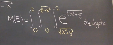 Below is the transcription of the mathematical expression found on the chalkboard, which appears to be part of a multivariable calculus or mathematical physics course on an educational website:

---

### Mathematical Expression for **M(E)**

\[
M(E) = \int_{0}^{2} \int_{0}^{\sqrt{4-x^2}} \int_{0}^{2} e^{-\sqrt{x^2 + y^2}} \frac{dz \, dy \, dx}{\sqrt{x^2 + y^2}}
\]

---

### Explanation:

This integral represents a multivariable function that could arise in various contexts such as physics or engineering. It involves three integrals with respect to \(x\), \(y\), and \(z\). The limits and integrand suggest that this could be related to a problem involving cylindrical or spherical coordinates, often used in evaluating volumes or electromagnetic fields.

1. **Integration Bounds:**
   - \( x \) ranges from \(0\) to \(2\).
   - \( y \) ranges from \(0\) to \(\sqrt{4-x^2}\).
   - \( z \) ranges from \(0\) to \(2\).

2. **Integrand:**
   - The exponential function \( e^{-\sqrt{x^2 + y^2}} \), which decays as a function of the distance from the origin in the \(xy\)-plane.
   - The term \( \frac{1}{\sqrt{x^2 + y^2}} \) under the integrand might relate to a potential function in cylindrical coordinates.

Such expressions are typically evaluated using numerical methods or advanced integration techniques due to their complexity.

---