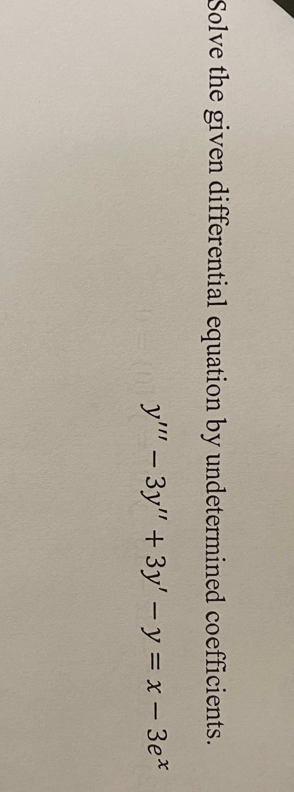 Solve the given differential equation by undetermined coefficients.
y'' – 3y" + 3y' – y = x – 3e*
|
